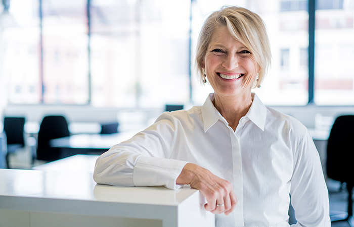 smiling business woman in white shirt