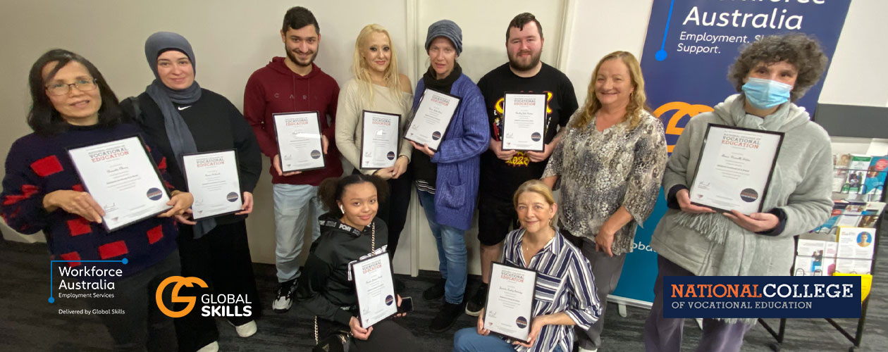 graduates holding their certificates