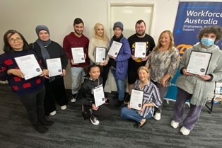 graduates holding their certificates