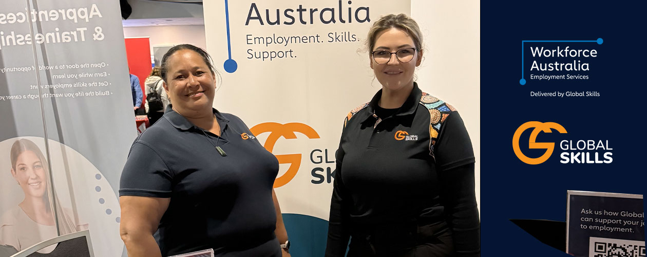 Our staff, Jennifer and Chloe, standing behind our stall table which contains branded merchandise