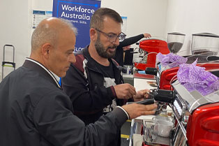 two students using coffee machine