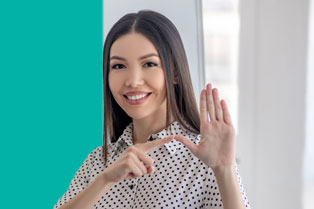 A woman using sign language in recognition of National Deaf Week