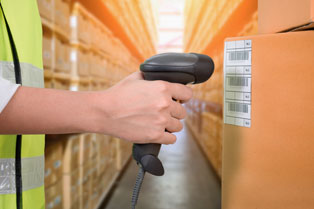 Female hand scanning a barcode on a label attached to a box