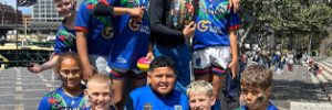 Jets U10s team outside the stadium where 2024 grand final was played