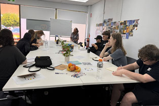 TtW job seekers sitting around a table completing a training task