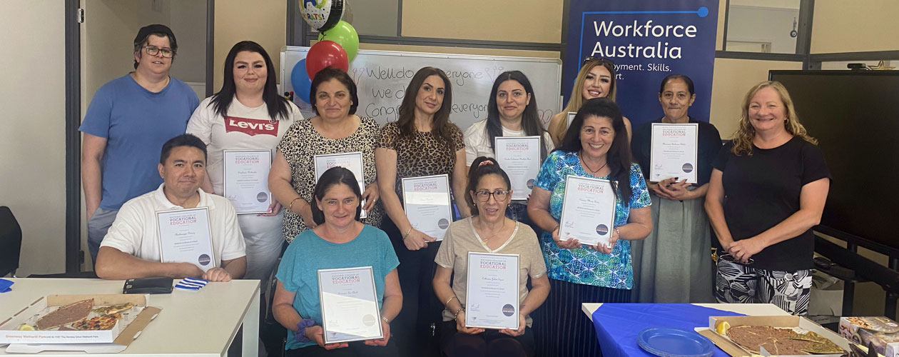 Graduates holding their certificates