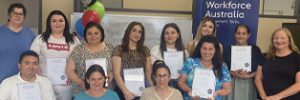 Graduates holding their certificates