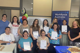 Graduates holding their certificates