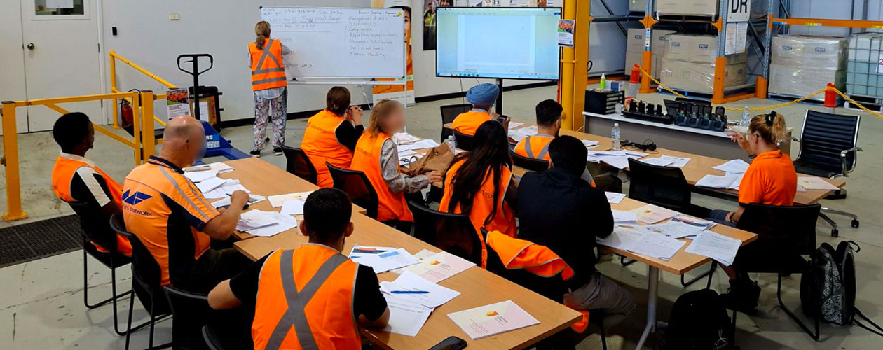 RF Scanning Skillset students learning at desks in a warehouse setting