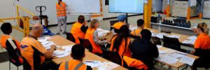 RF Scanning Skillset students learning at desks in a warehouse setting