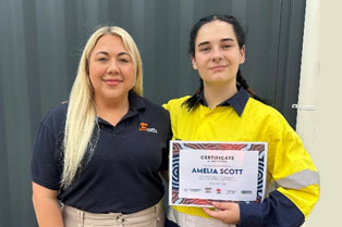 Amelia proudly holding her certificate alongside Employment Consultant Hayley